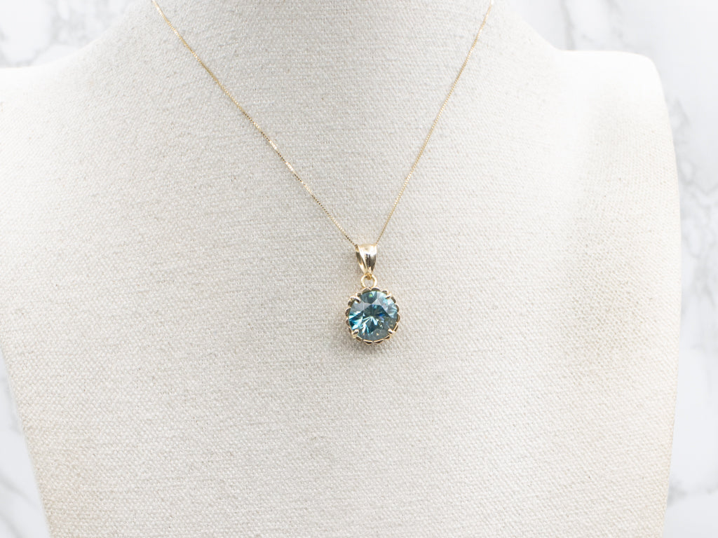 Blue Zircon Solitaire Pendant in Scalloped Gold Setting