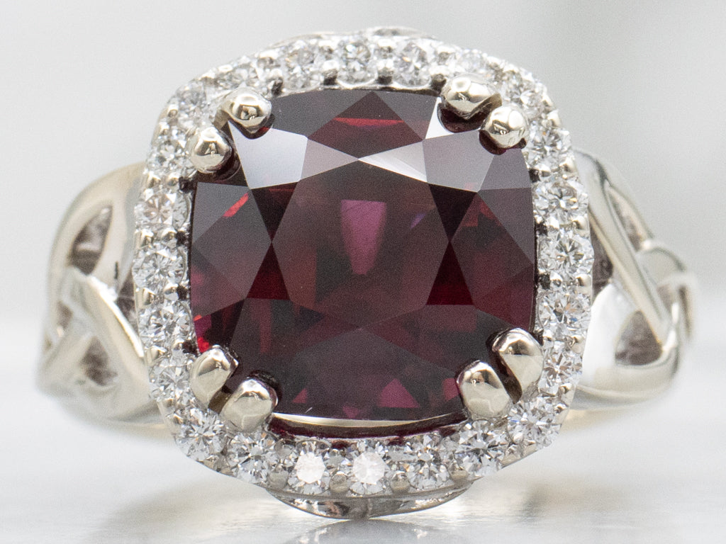 Garnet and Diamond Halo White Gold Ring with Celtic Trinity Knot