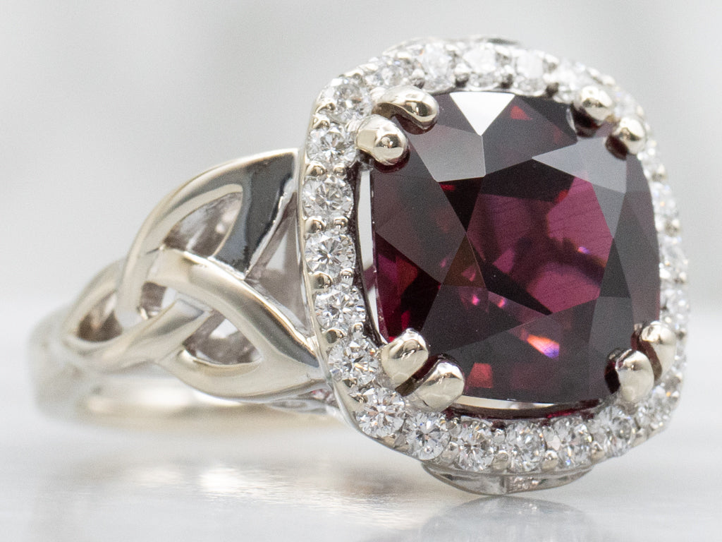 Garnet and Diamond Halo White Gold Ring with Celtic Trinity Knot