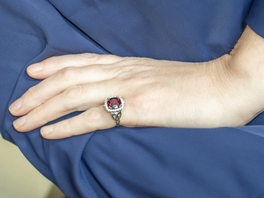 Garnet and Diamond Halo White Gold Ring with Celtic Trinity Knot
