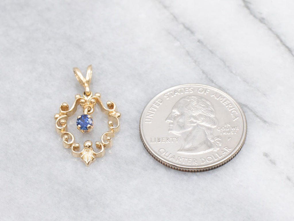 Scrolling Yellow Gold Pendant with Swinging Sapphire Drop