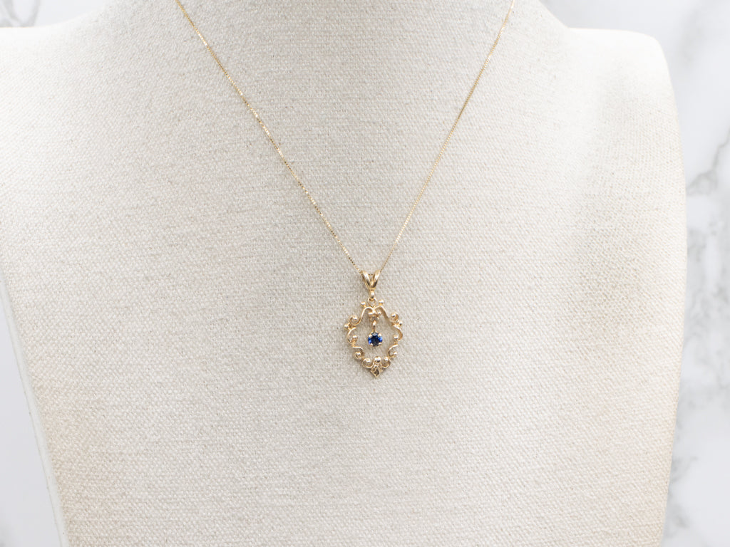 Scrolling Yellow Gold Pendant with Swinging Sapphire Drop