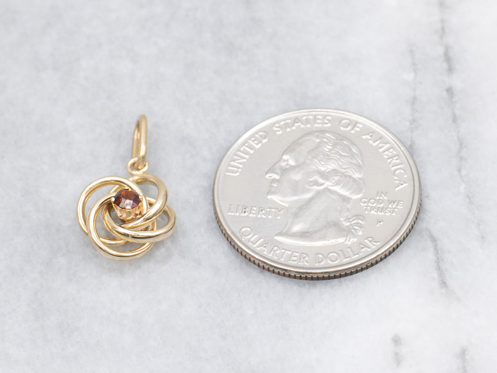 Yellow Gold Garnet Lovers Knot Pendant