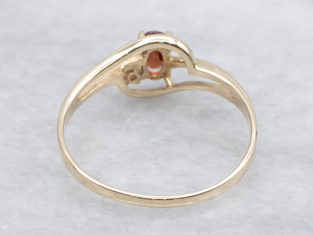Vintage Gold and Garnet Bypass Ring with Diamond Accent
