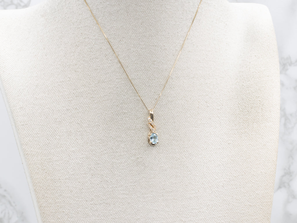 Blue Topaz and Diamond Twisting Gold Pendant