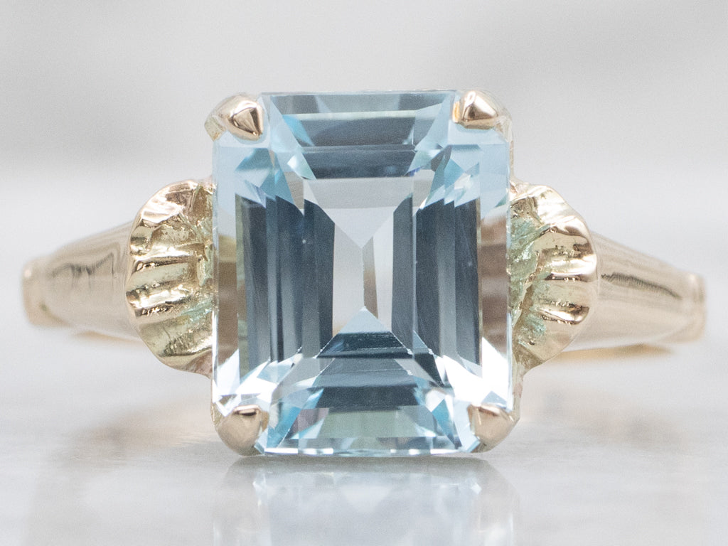 Emerald-Cut Blue Topaz and Gold Solitaire Ring