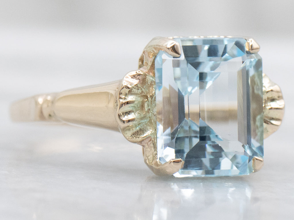 Emerald-Cut Blue Topaz and Gold Solitaire Ring
