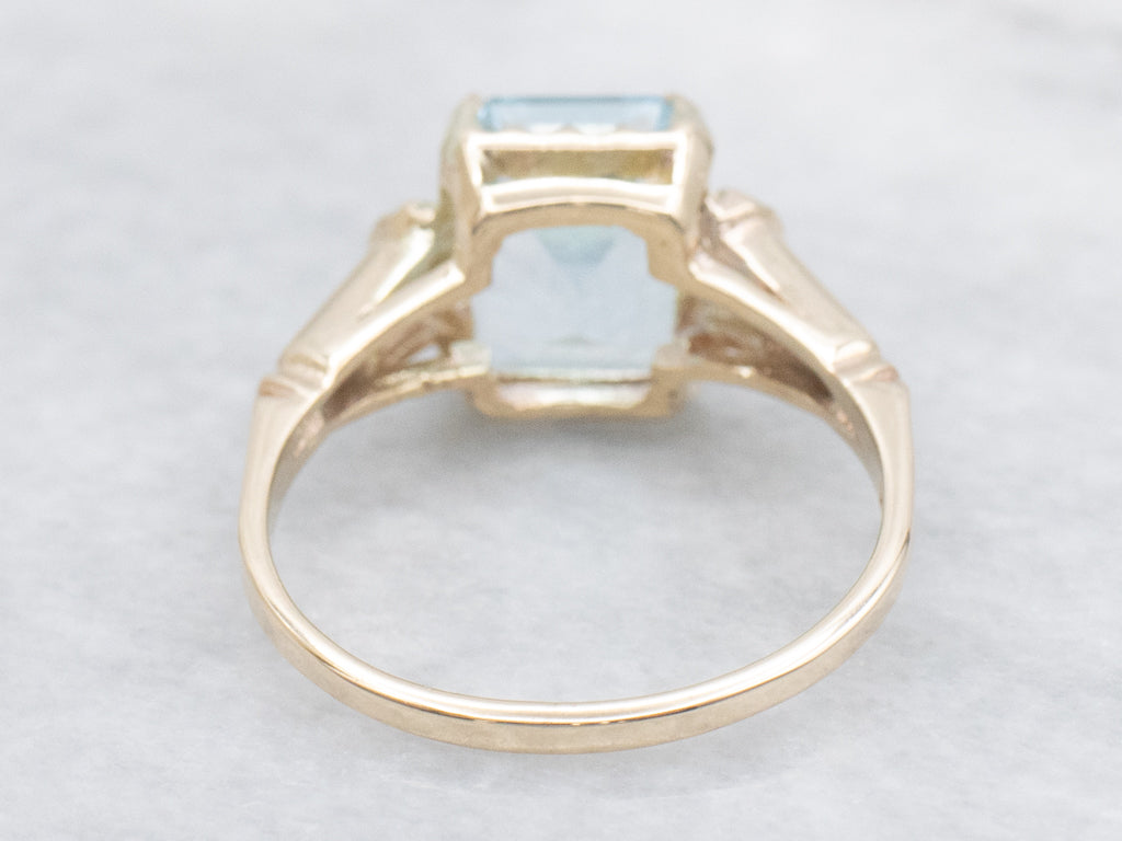 Emerald-Cut Blue Topaz and Gold Solitaire Ring