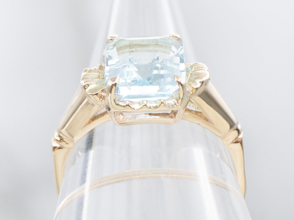 Emerald-Cut Blue Topaz and Gold Solitaire Ring