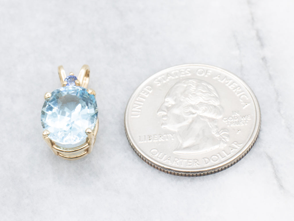 Yellow Gold Blue Topaz Pendant with Sapphire Accent