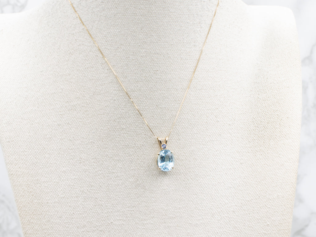 Yellow Gold Blue Topaz Pendant with Sapphire Accent