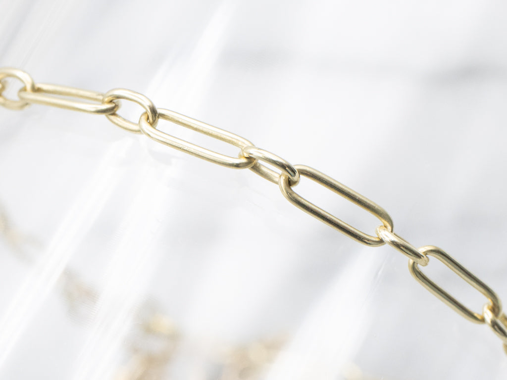 Yellow Gold Alternating Oval Link Bracelet with Floral Filigree Padlock Heart