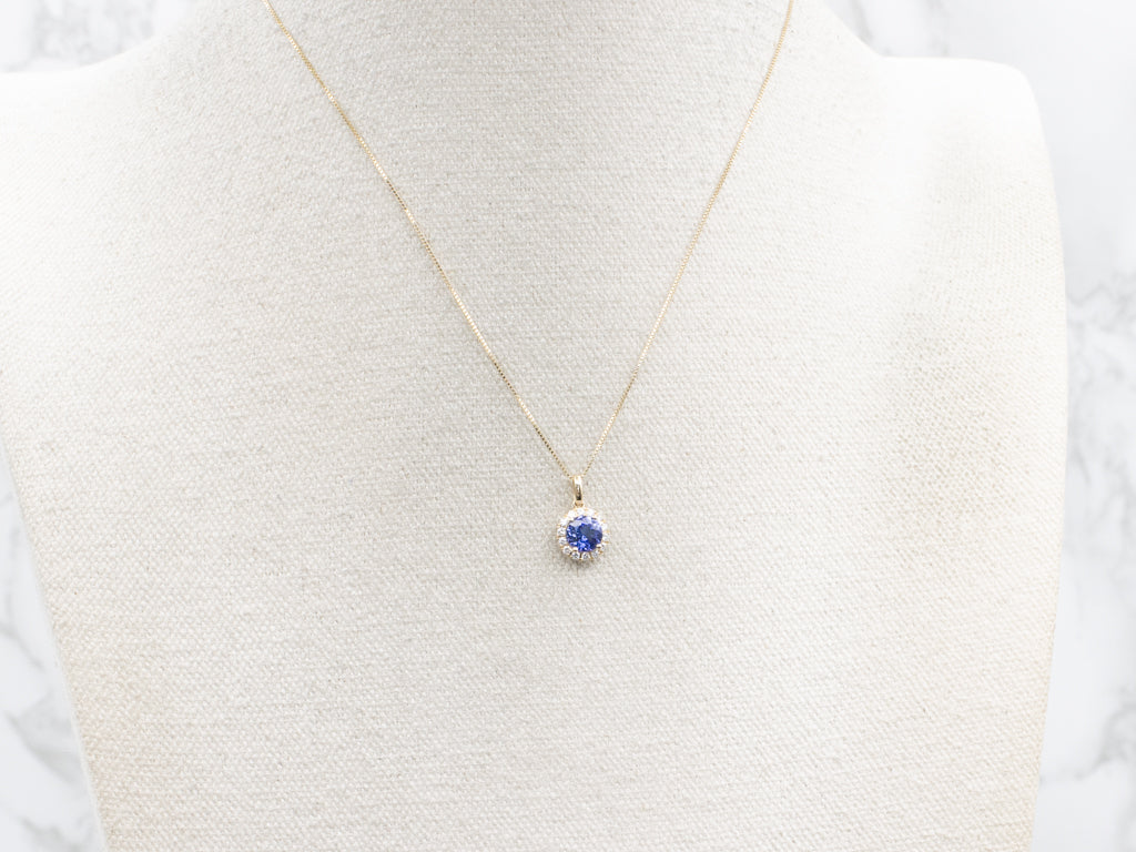 Modern Tanzanite and Diamond Halo Gold Pendant