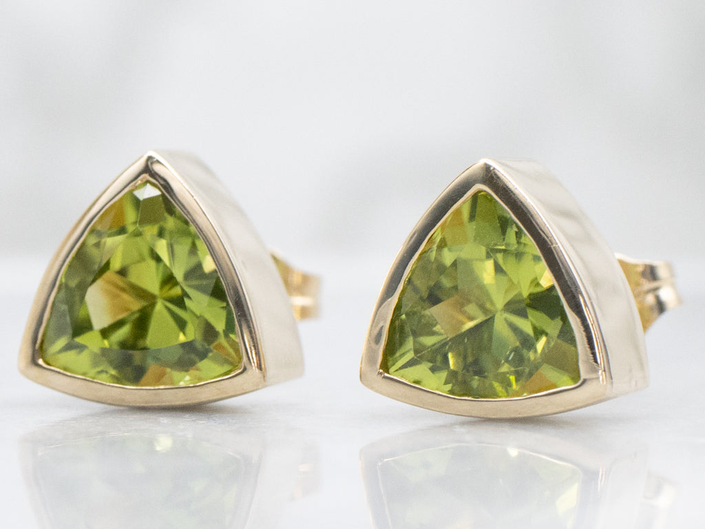 Sleek Bezel-Set Trillion-Cut Peridot Gold Stud Earrings