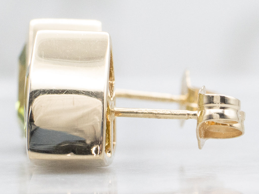 Sleek Bezel-Set Trillion-Cut Peridot Gold Stud Earrings