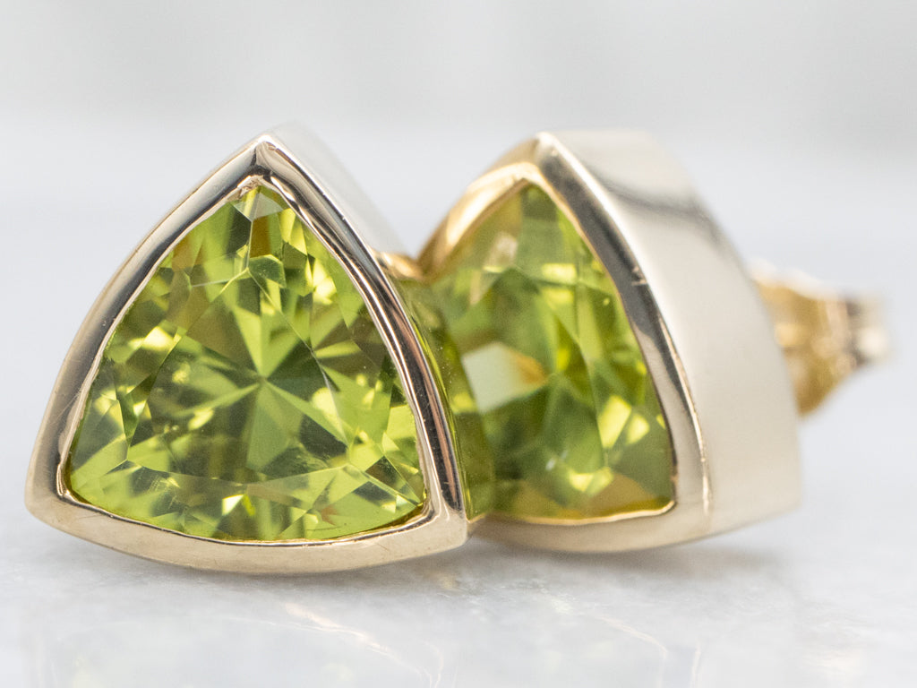 Sleek Bezel-Set Trillion-Cut Peridot Gold Stud Earrings