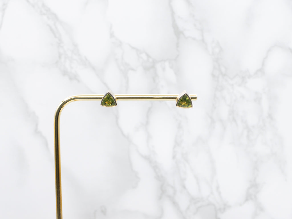 Sleek Bezel-Set Trillion-Cut Peridot Gold Stud Earrings