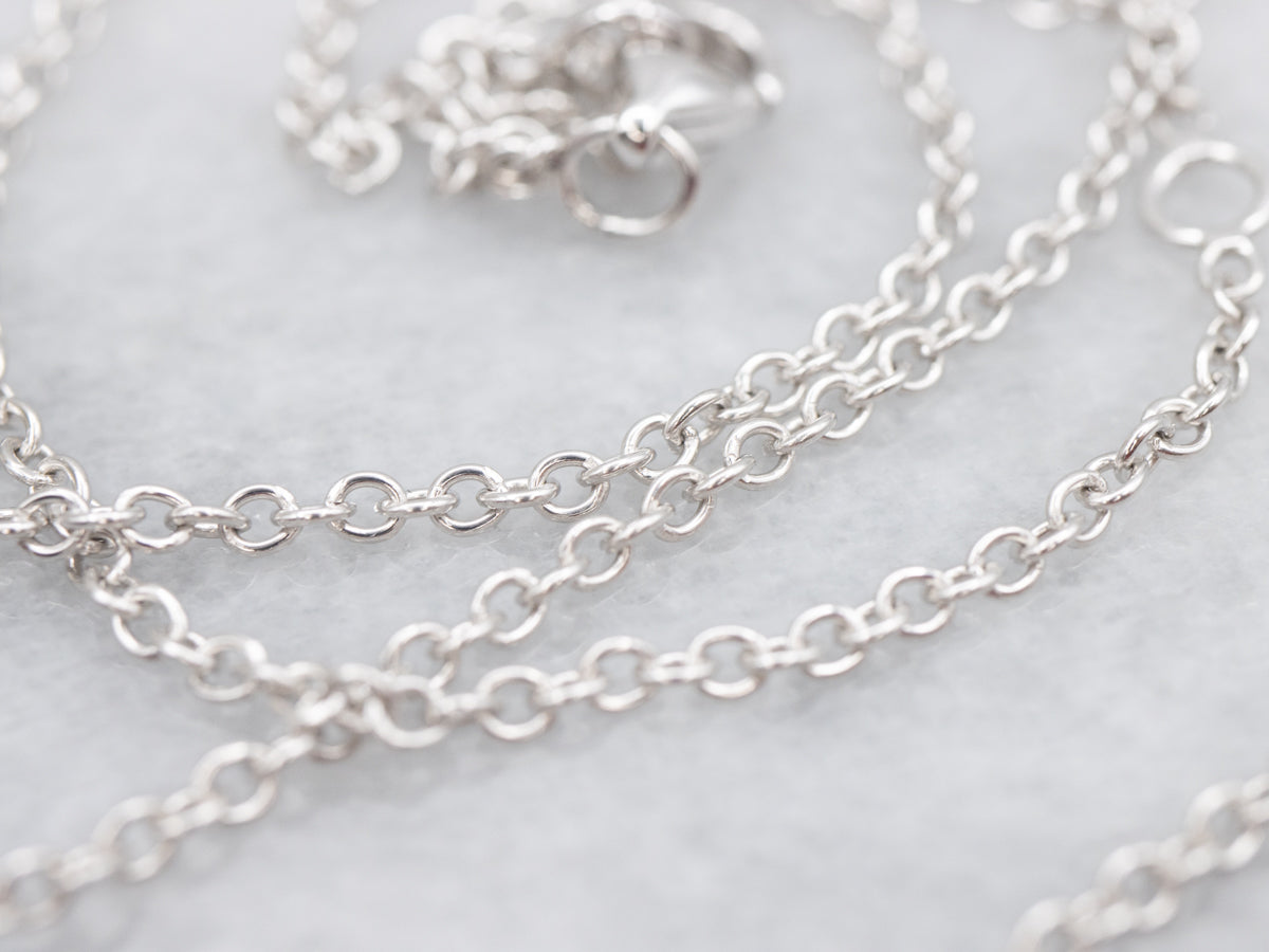 Modern East-to-West Sapphire and Diamond Halo Pendant on Cable Chain