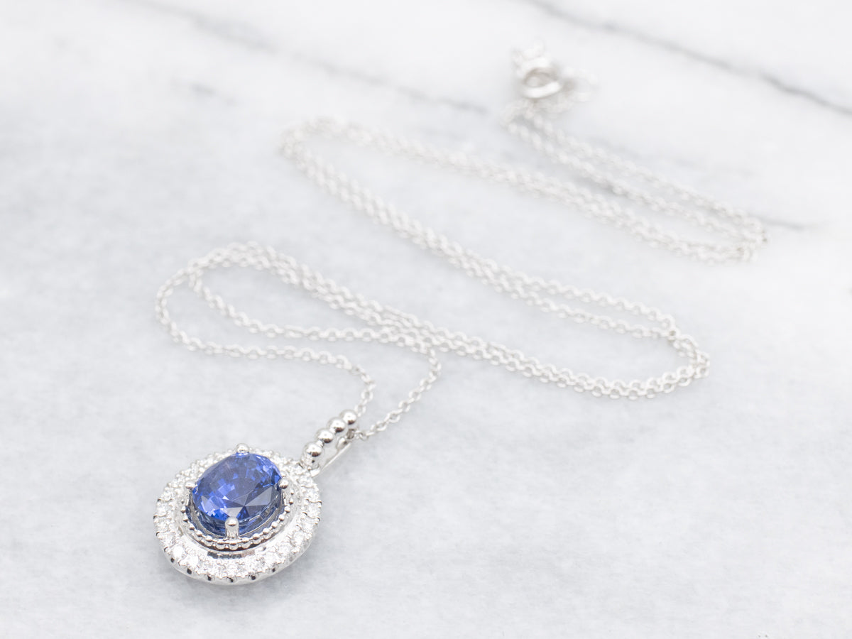 Modern Sapphire and Diamond Halo Pendant Necklace