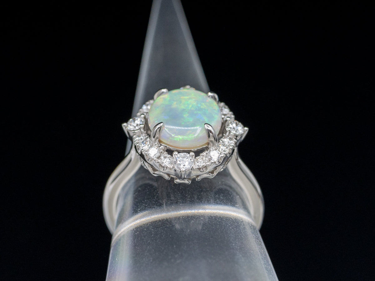 Anillo de cóctel con halo de diamantes y ópalo ovalado en oro blanco de 14 quilates
