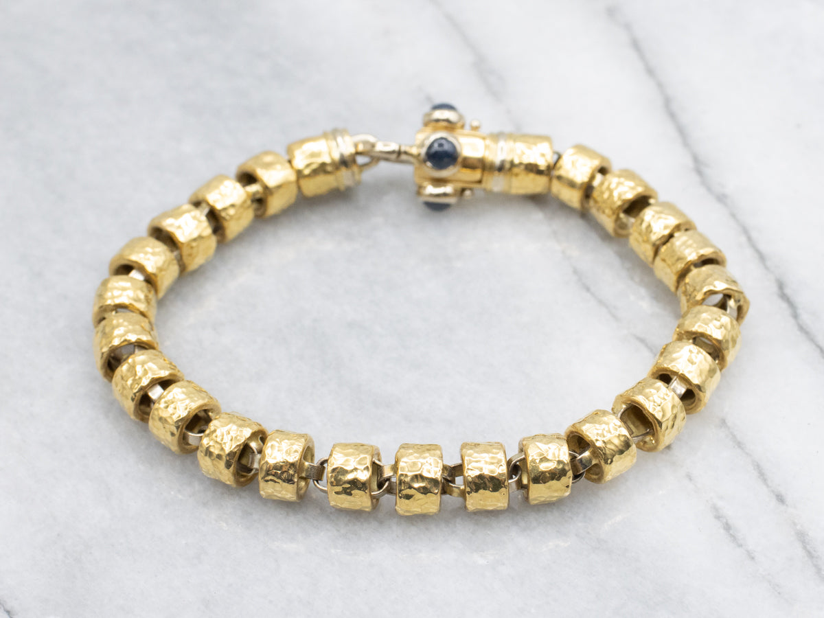 18-Karat Gold Bracelet with Faceted Links and Decorative Sapphire Cabochon Clasp