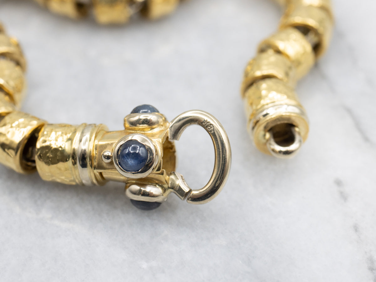 18-Karat Gold Bracelet with Faceted Links and Decorative Sapphire Cabochon Clasp
