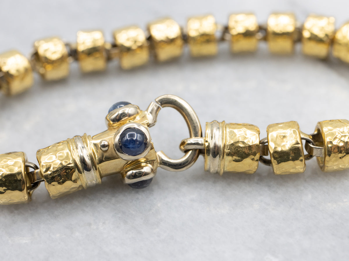 18-Karat Gold Bracelet with Faceted Links and Decorative Sapphire Cabochon Clasp