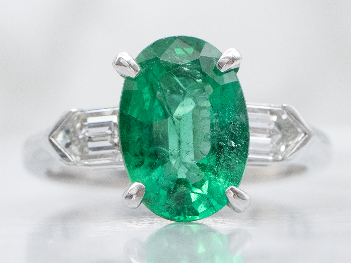 Modern Platinum Emerald Engagement Ring with Fancy-Cut Diamond Accents