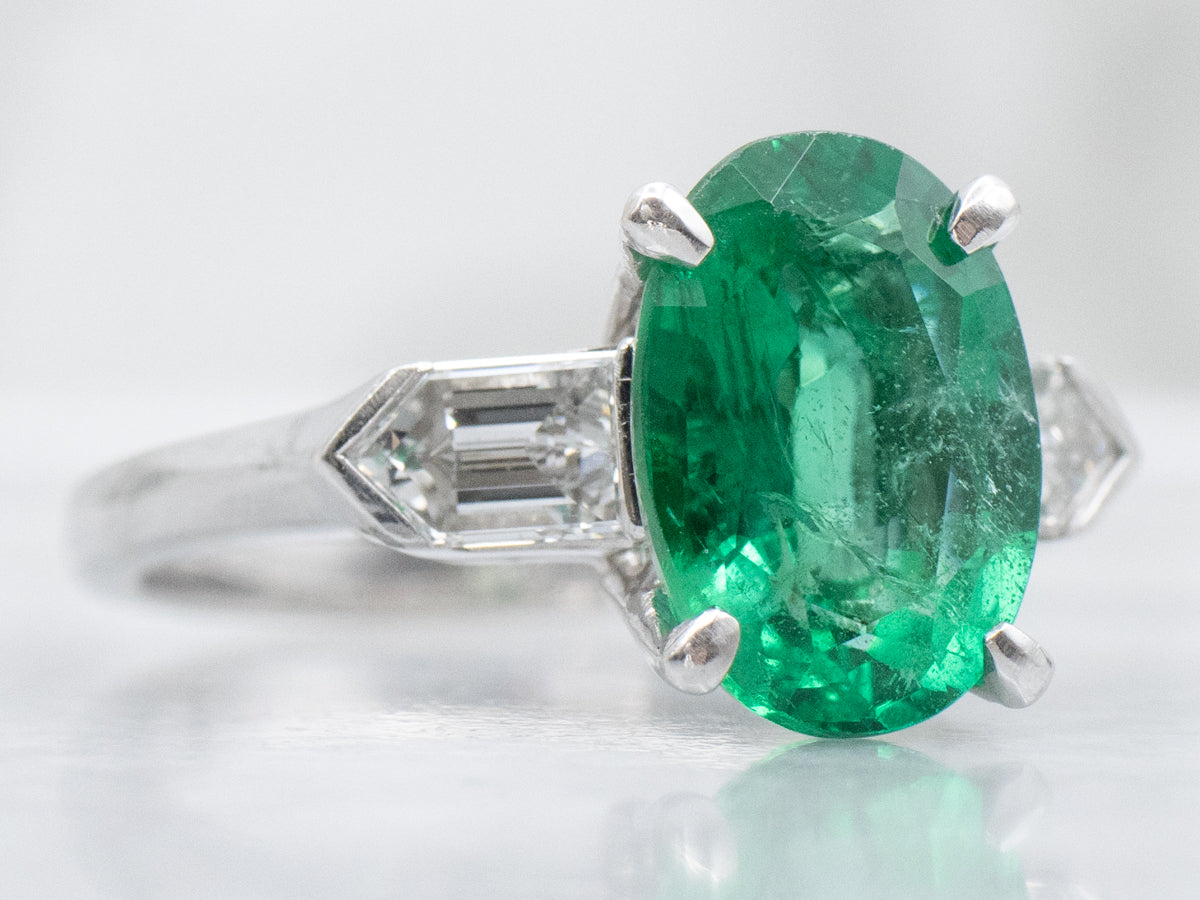 Modern Platinum Emerald Engagement Ring with Fancy-Cut Diamond Accents