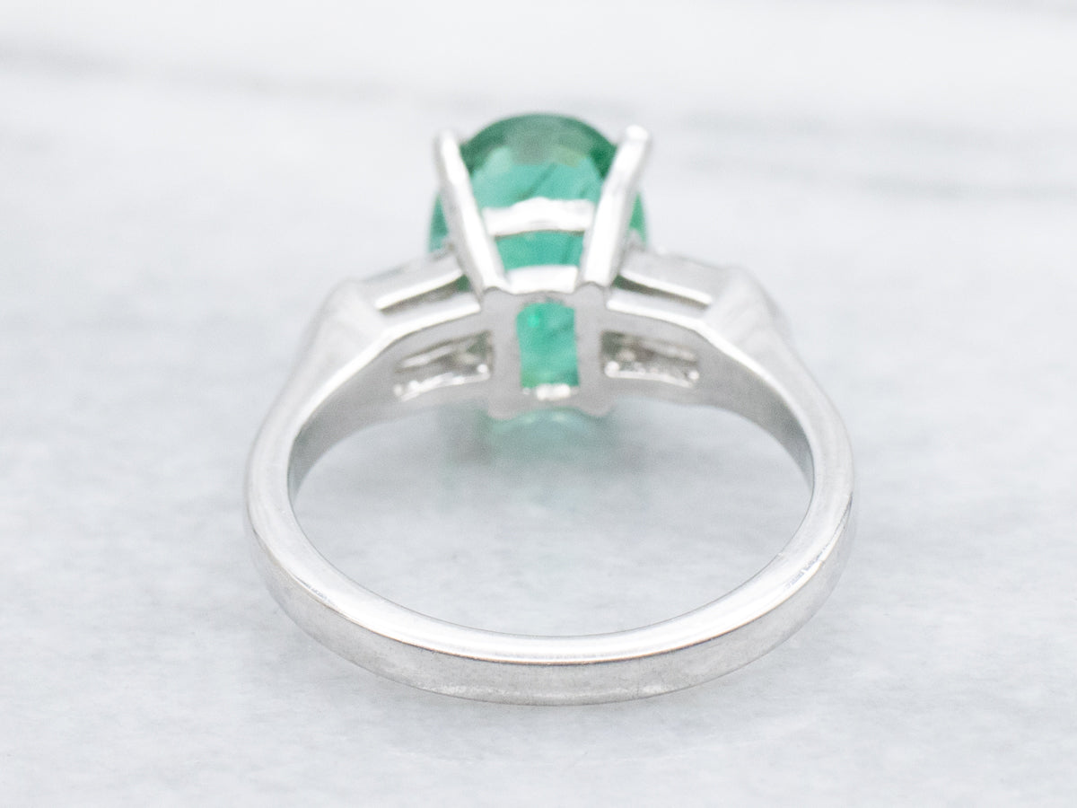 Modern Platinum Emerald Engagement Ring with Fancy-Cut Diamond Accents