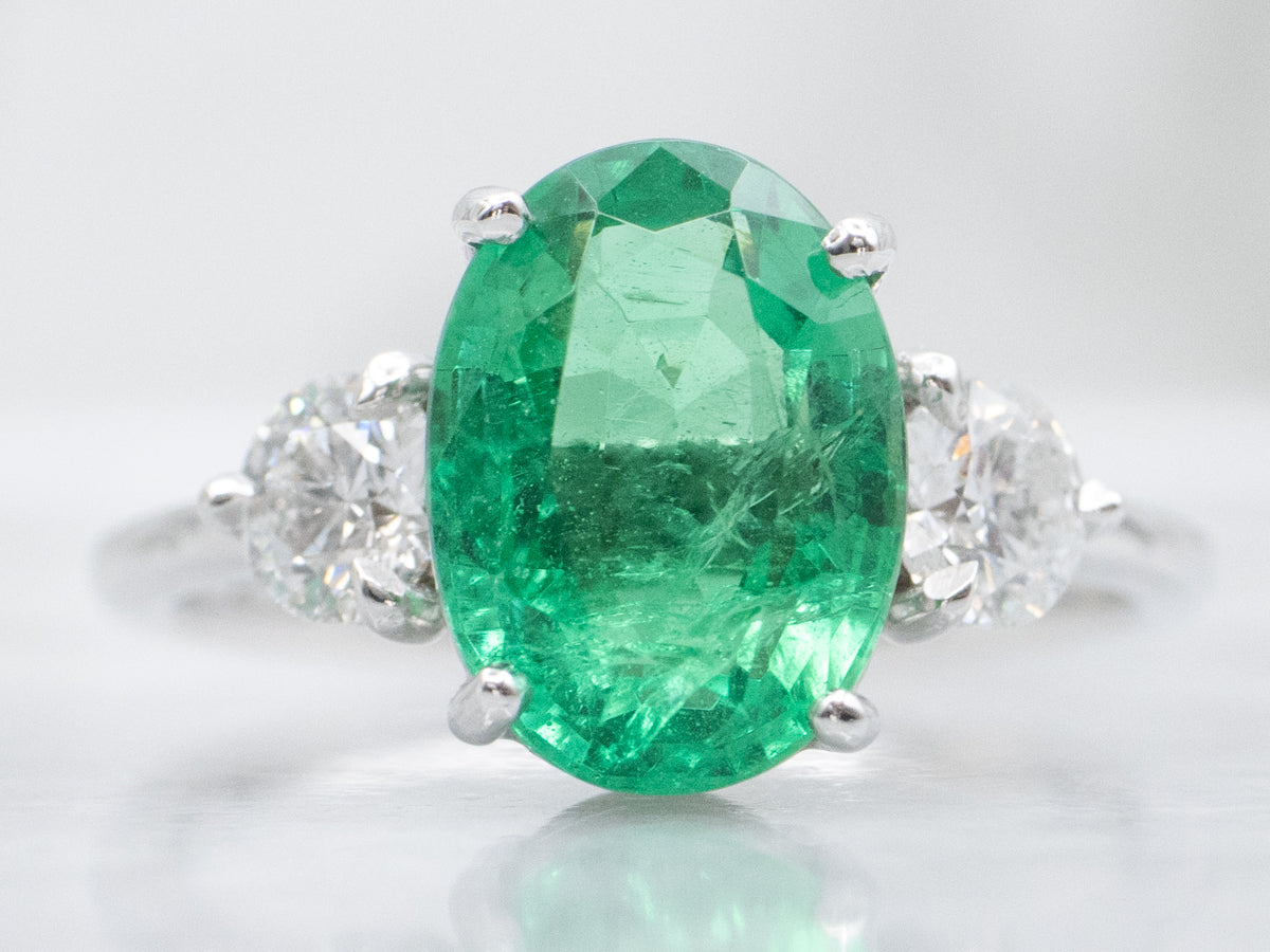 Modern Oval-Cut Emerald and Diamond Three Stone Ring