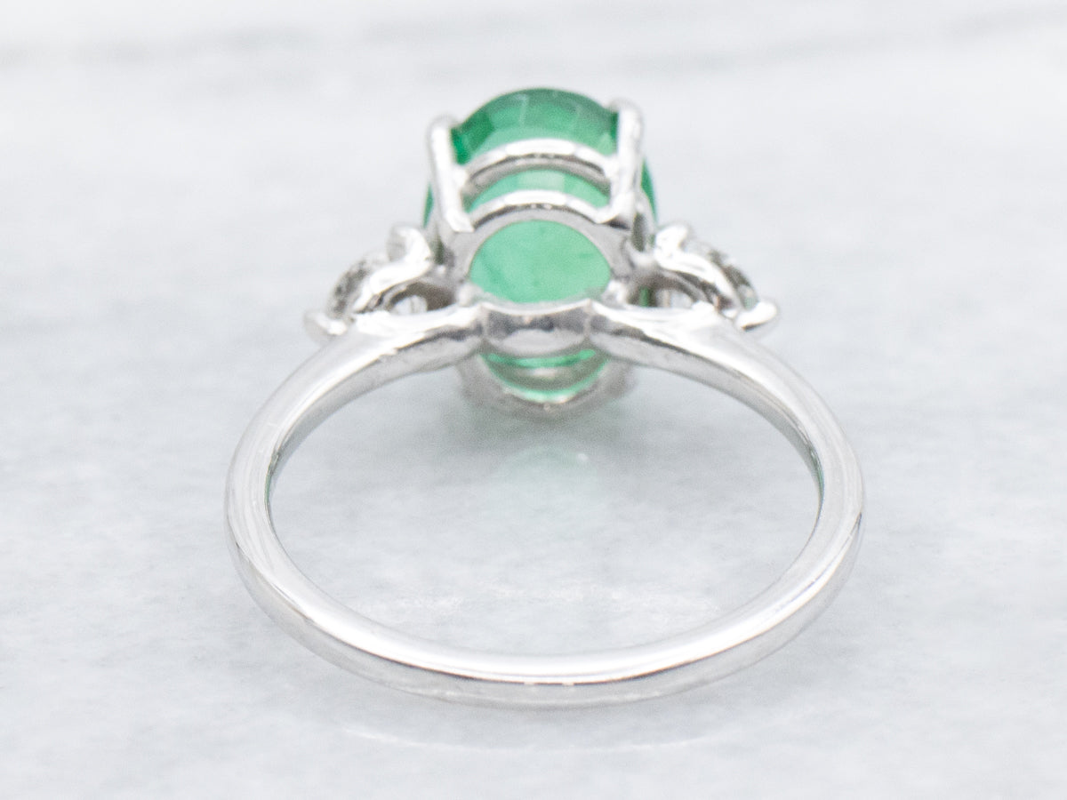 Modern Oval-Cut Emerald and Diamond Three Stone Ring