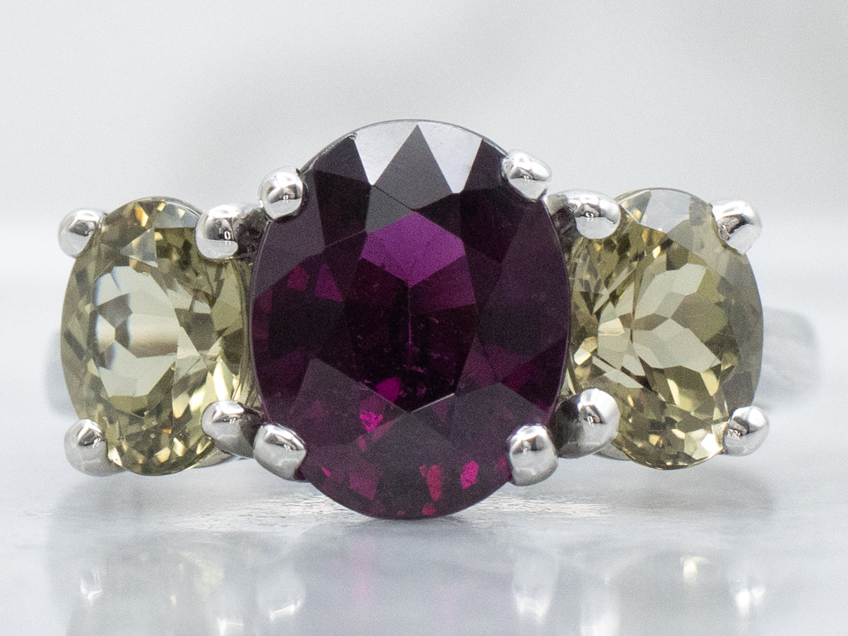 Platinum Rhodolite Garnet and Green Kornerupine Three-Stone Ring