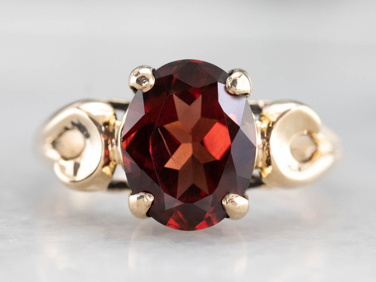 Garnet Scrolling Gold Solitaire Ring