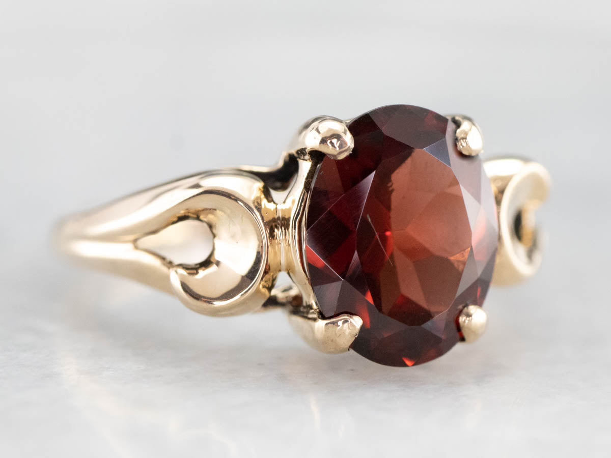Garnet Scrolling Gold Solitaire Ring