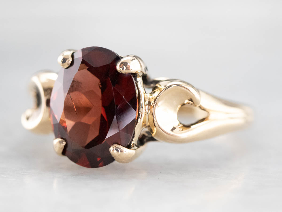 Garnet Scrolling Gold Solitaire Ring