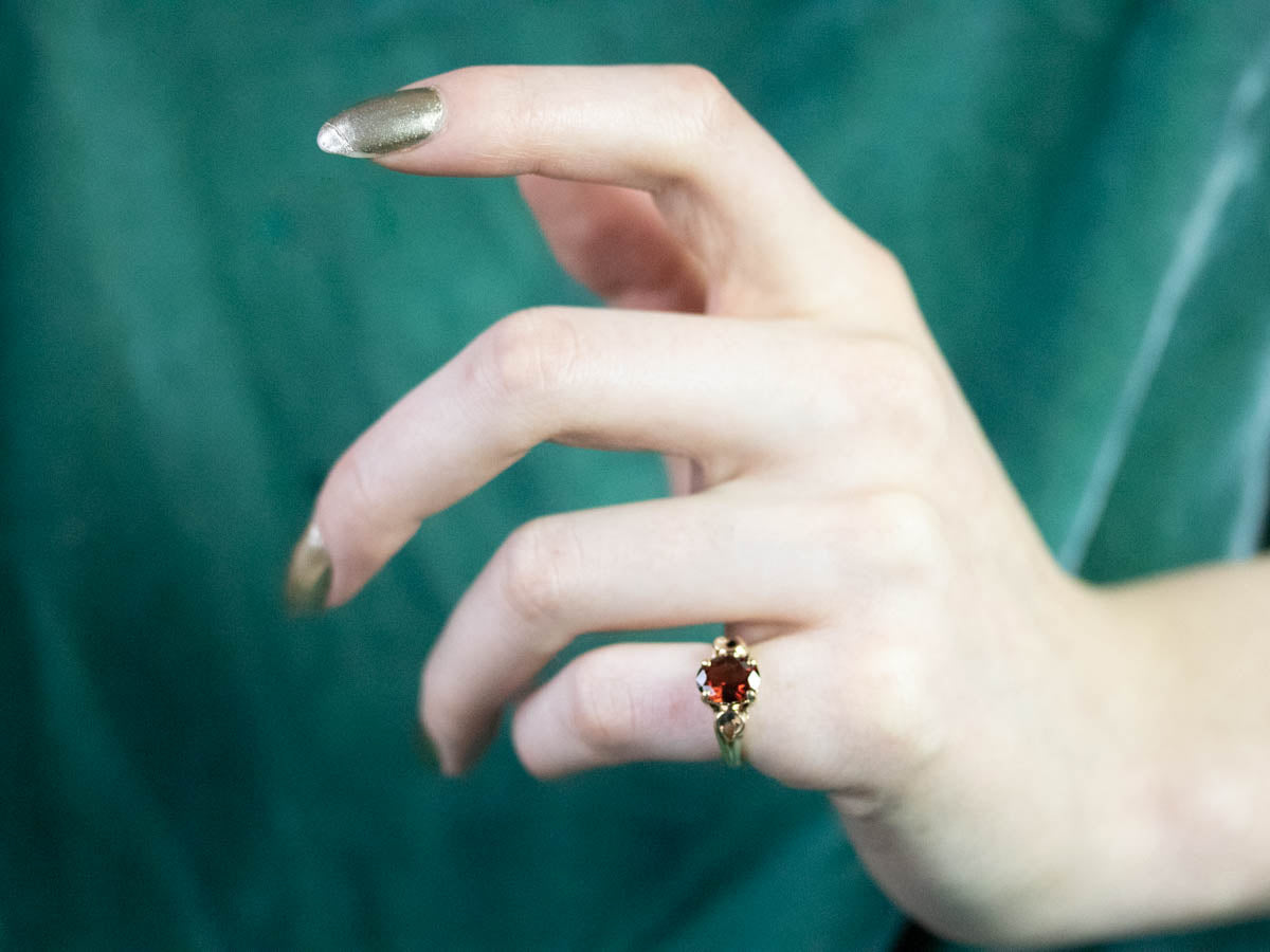 Garnet Scrolling Gold Solitaire Ring
