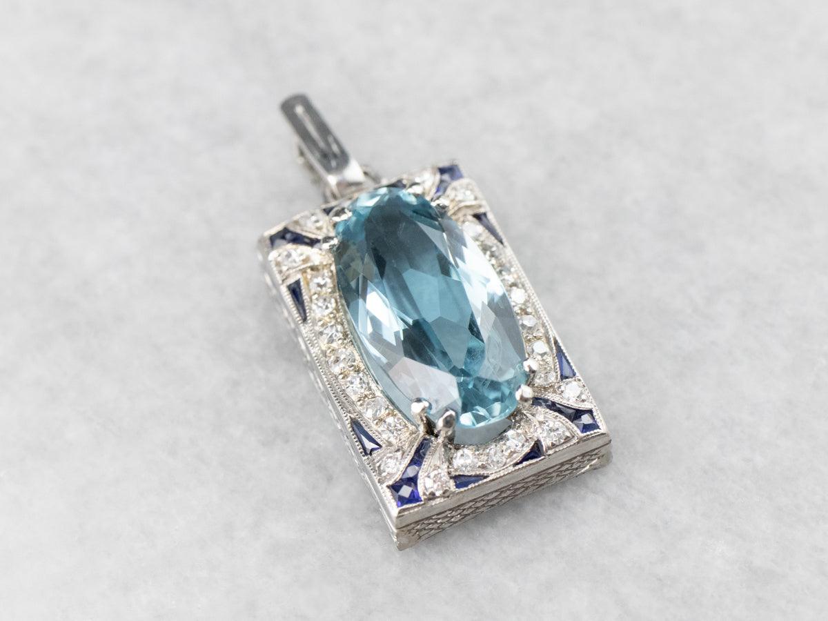 Colgante de oro blanco con diamantes y topacio azul