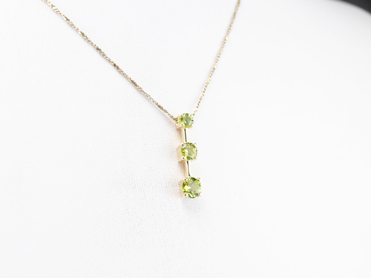 Graduated Three Stone Peridot Gold Pendant
