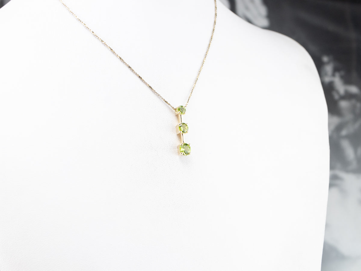 Graduated Three Stone Peridot Gold Pendant