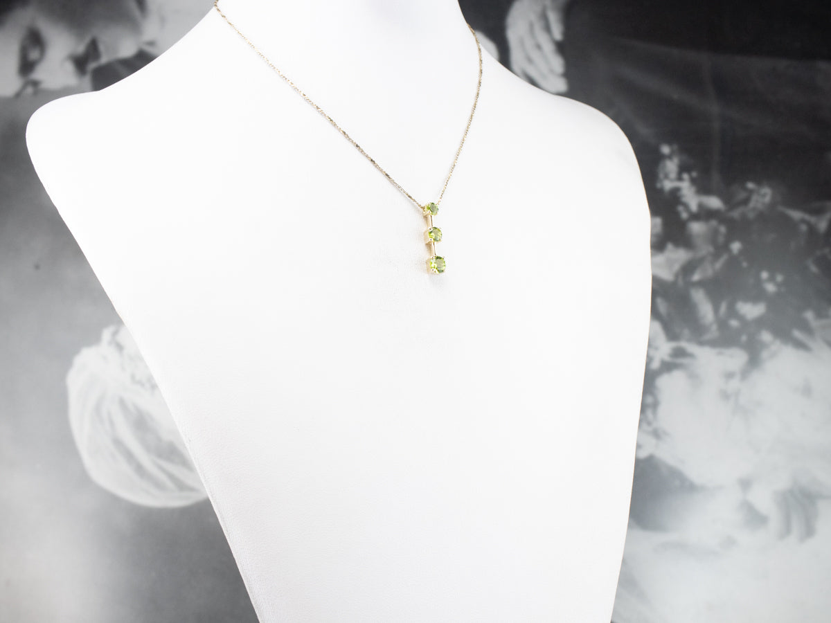 Graduated Three Stone Peridot Gold Pendant