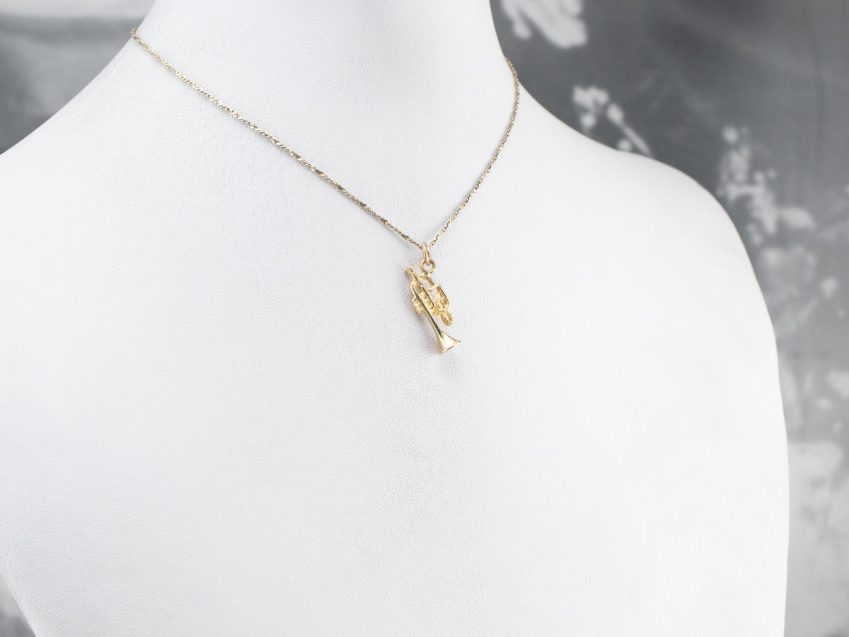 Dije de trompeta de oro de 14 quilates