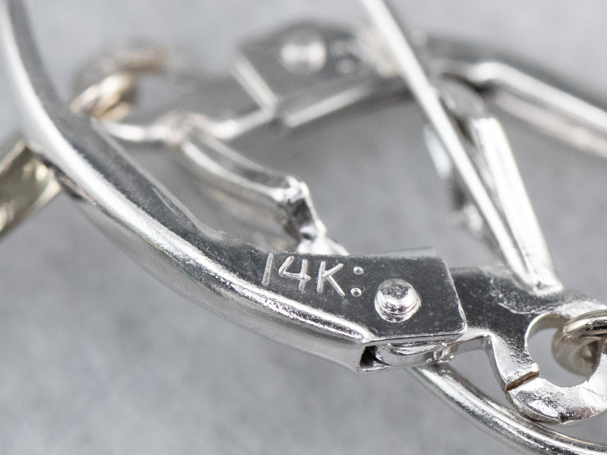 Pendientes con circonitas azules y barra grabada