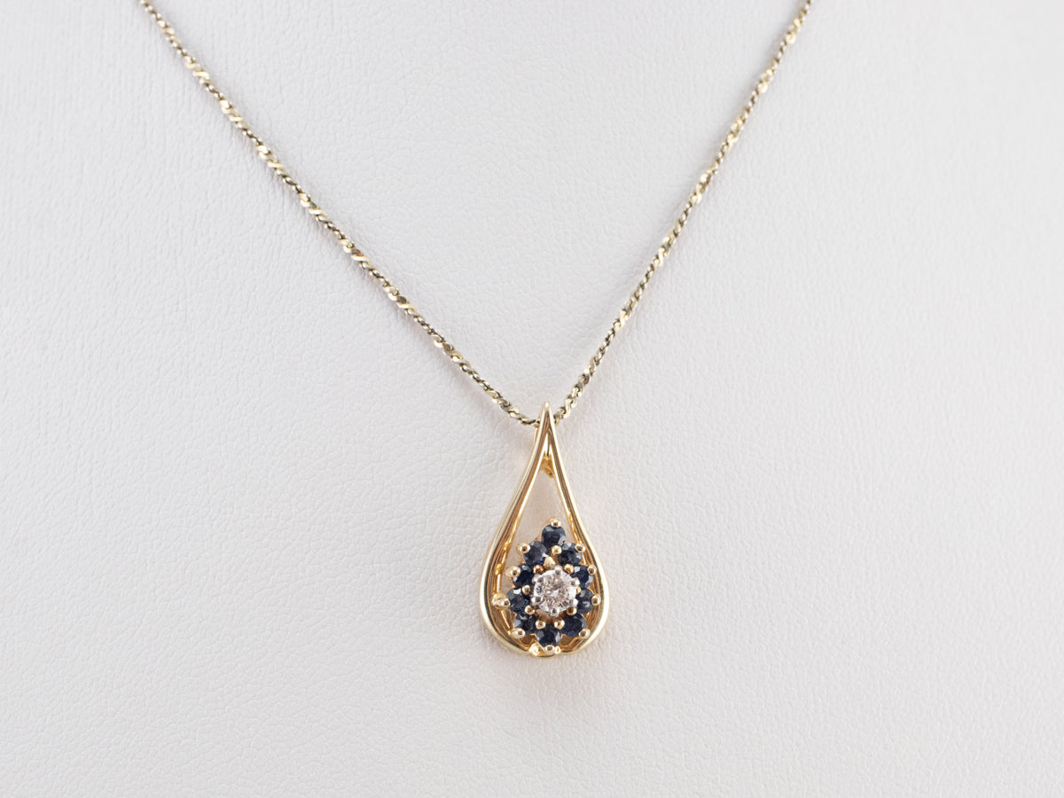 Colgante floral con halo de diamantes y zafiros