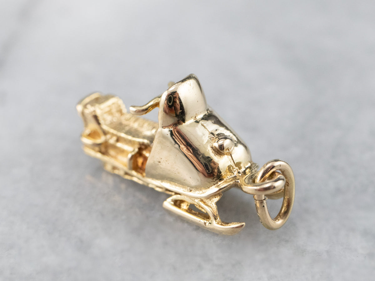 Charm de moto de nieve dorado
