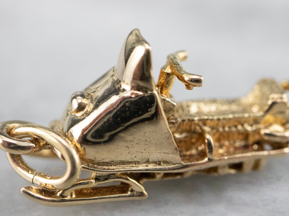 Charm de moto de nieve dorado