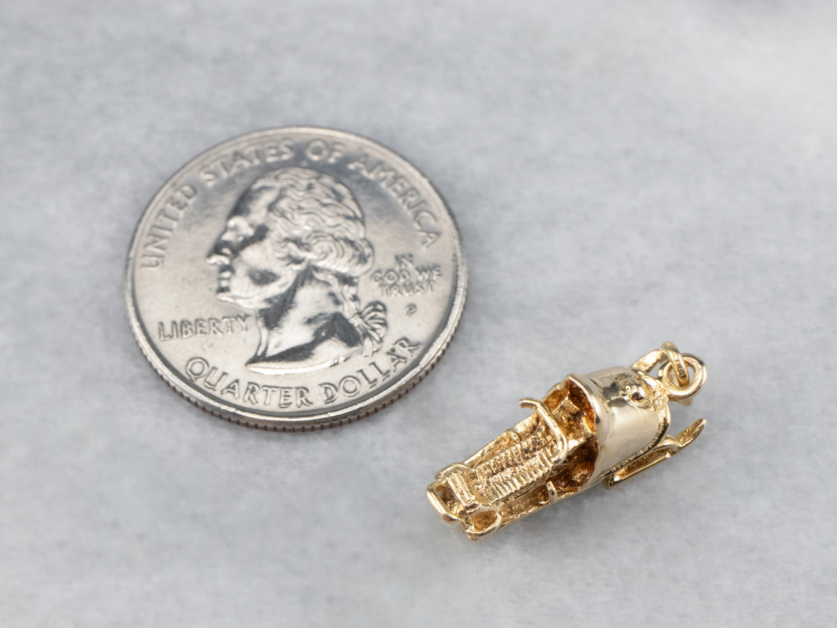 Charm de moto de nieve dorado