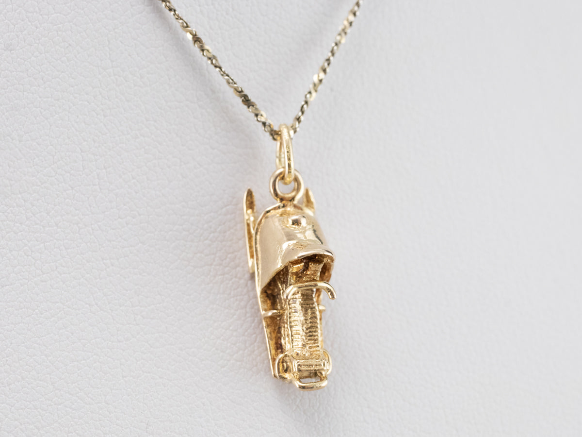 Charm de moto de nieve dorado