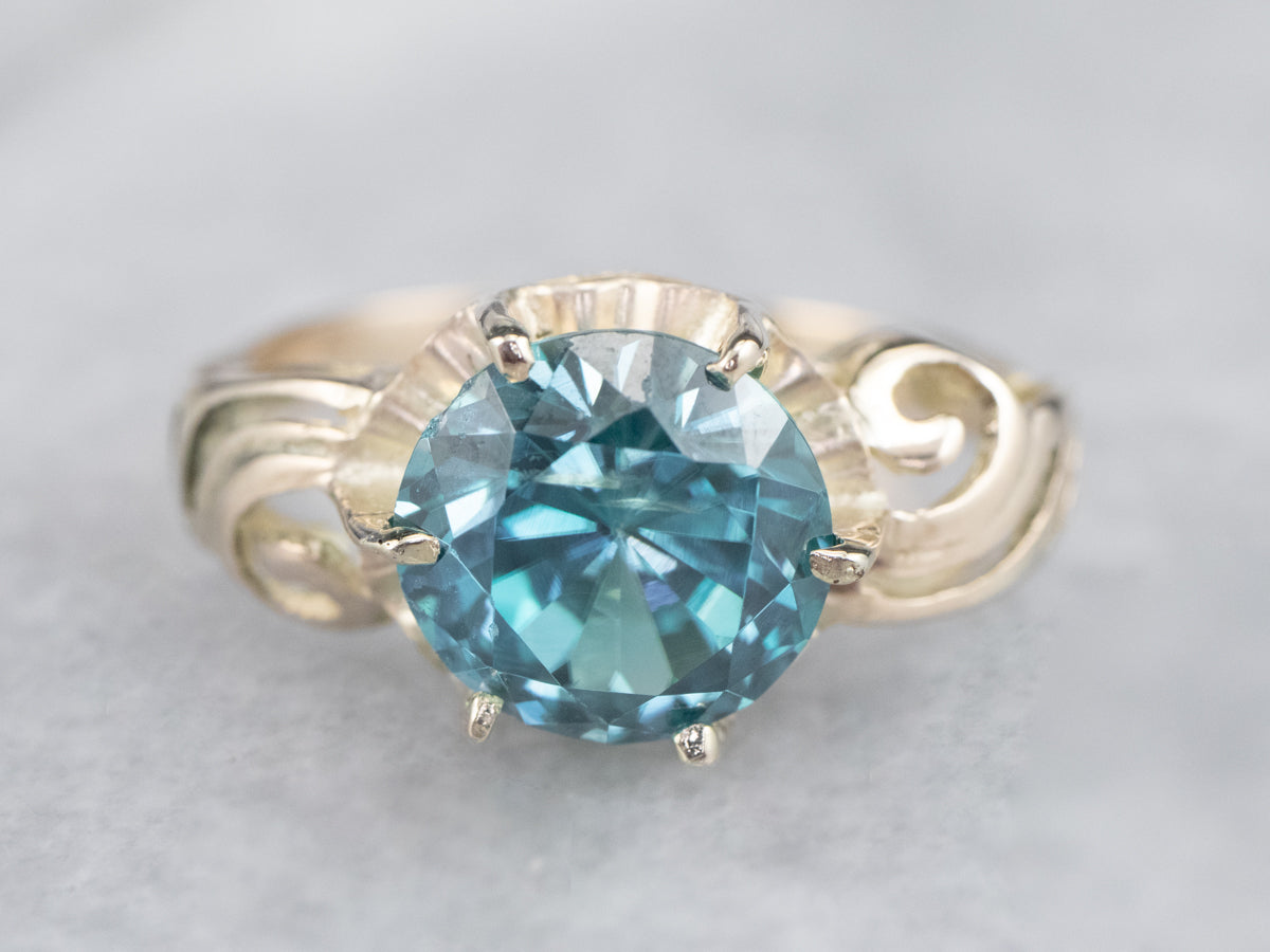 Vivid Teal Blue Zircon in Swirly Gold Buttercup Setting