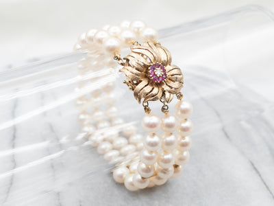 1960's Yellow Gold Ruby and Diamond Three Strand Pearl Bracelet with Flower Clasp